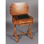 A VICTORIAN WALNUT VENEERED WORK TABLE, of rounded rectangular form, the hinged lid revealing