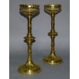 A PAIR OF 19TH CENTURY BRASS CANDLESTICKS on ring turned columns each with a bladed knop, raised
