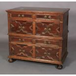 A CHARLES II OAK AND CEDARWOOD CHEST, having a moulded top above alternating shallow and deep