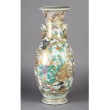 A JAPANESE VASE c.1900 of baluster form painted with flowers, birds and pavilions in shaped
