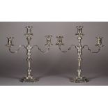 A PAIR OF GEORGE II STYLE SILVER TWO BRANCH THREE LIGHT CANDELABRUM with knopped octagonal stems and