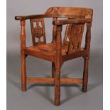 A THOMPSON OF KILBURN 'MOUSEMAN' OAK MONK'S CHAIR the top rail terminating with a face mask to