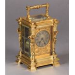 A LATE 19TH CENTURY BRASS CASED HOUR REPEATING CARRIAGE CLOCK, the case cast with male bearded
