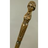 AN OAK WALKING STICK the terminal carved with a classical female head above foliate carved fluted