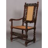 A CHARLES II WALNUT ARMCHAIR 17TH CENTURY AND LATER, having a pierced cresting carved with an