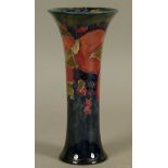 A WILLIAM MOORCROFT POMEGRANATE DESIGN VASE, c.1916, cylindrical with a flared neck and foot,