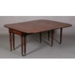 A REGENCY MAHOGANY EXTENDING DINING TABLE, rectangular with rounded end panels, the frieze inlaid