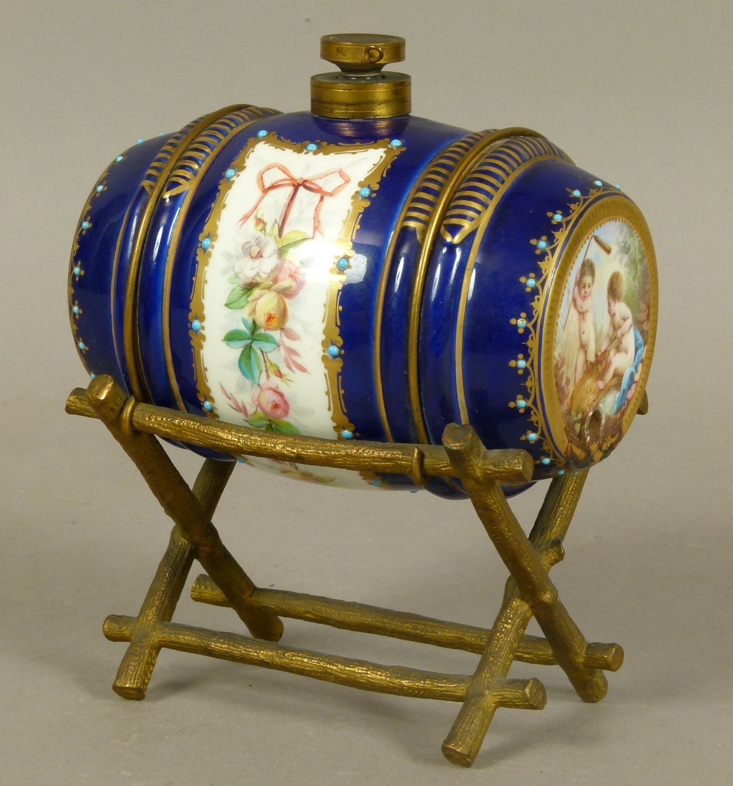 A LATE 19TH CENTURY FRENCH PORCELAIN AND GILT-BRONZE MOUNTED SPIRIT BARREL, the porcelain barrel