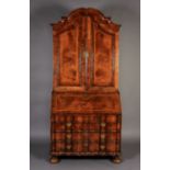 A MID-TO LATE 18TH CENTURY WALNUT VENEERED BUREAU BOOKCASE, the arched top with cavetto moulded