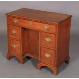 A GEORGE III MAHOGANY KNEEHOLE DESK, the rectangular top with applied moulded lip above one long