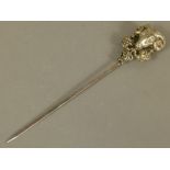 A CONTINENTAL SILVER COLOURED METAL MEAT SKEWER, the terminal embossed with a ram mask, hung