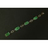 A JADE BRACELET IN 14CT WHITE GOLD c.1945 the four rectangular pierced and carved plaques claw set