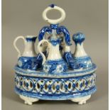 A 19TH CENTURY CONTINENTAL POTTERY CRUET STAND of oval form, decorated in underglaze blue, the stand