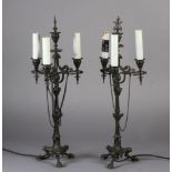 A PAIR OF NAPOLEON III BRONZE TABLE LAMPS, each having three lights on scrolled arms, on a fluted