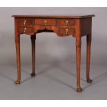 A GEORGE II STYLE WALNUT SIDE TABLE, the rectangular top with re-entrant front corners above one