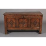 A LATE 17TH CENTURY OAK KIST the hinged single plank top with moulded lip above a lunettes carved