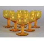 A SET OF SIX AMBER GLASS SMALL WINES each bowl wheel engraved with a cockfighting scene, tapered air