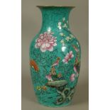 A CHINESE FAMILLE VERTE VASE of baluster form, painted with exotic birds, rocks issuing magnolia and