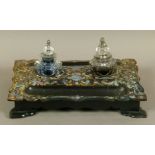 A VICTORIAN PAPIER MACHE DESK STANDISH having painted and mother-of-pearl decoration, twin pen