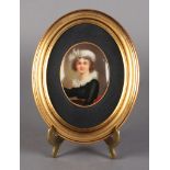 A CONTINENTAL PORCELAIN OVAL PORTRAIT PLAQUE, head and shoulders, she wears a white turban, black