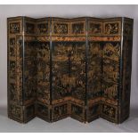 A CHINESE EIGHT FOLD BLACK LACQUER AND GILT DECORATED SCREEN, the central continuous panel with