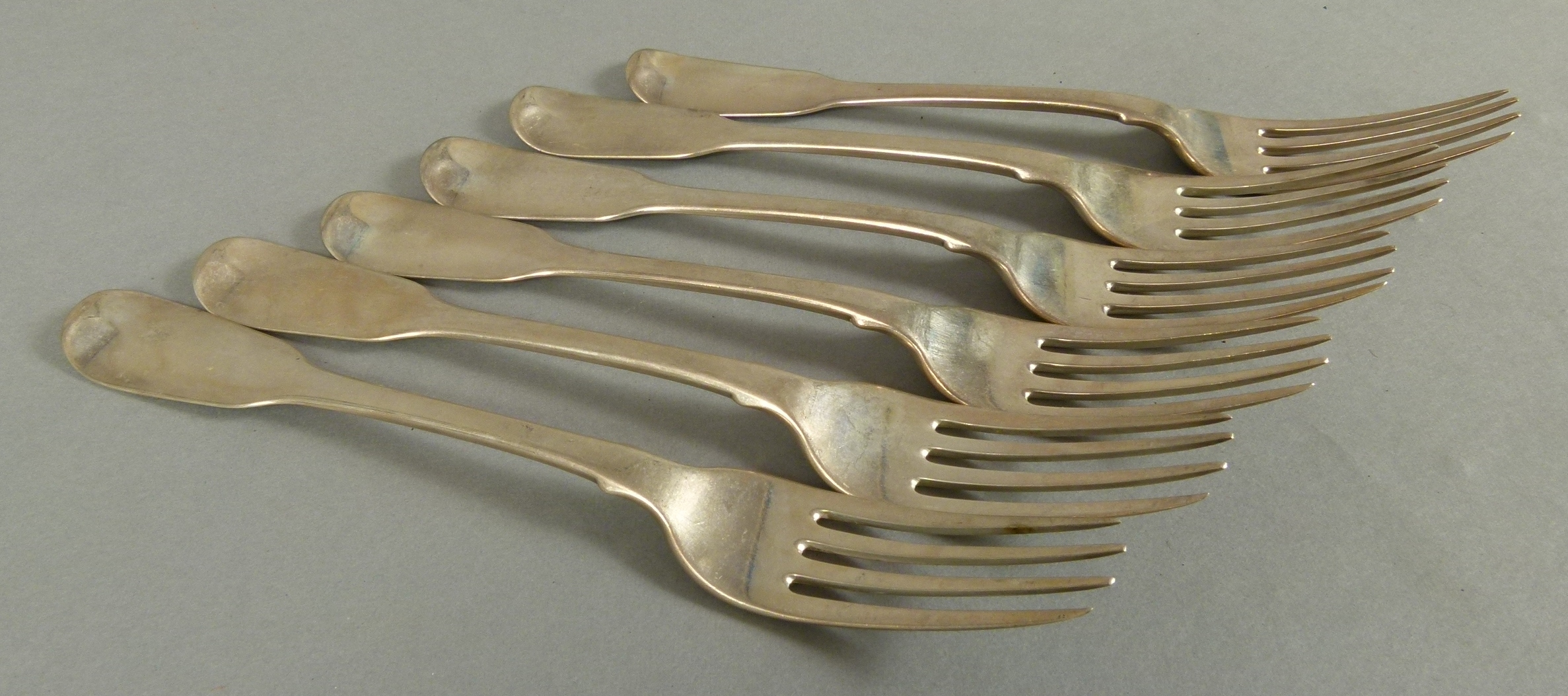 A SET OF SIX GEORGE IV FIDDLE PATTERN TABLE FORKS engraved with a crest, by Francis Higgins,