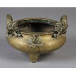 A CHINESE BRONZE TWO HANDLED CENSER of compressed cauldron form, the handles formed as sinuous