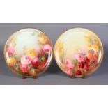 A PAIR OF LARGE ROYAL DOULTON PLATES BY W M BIRKBECK, each painted with yellow and pink roses, one