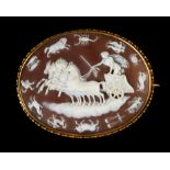 A VICTORIAN SHELL CAMEO BROOCH in 15ct gold, the oval landscape carving of Aurora crossing the