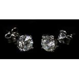 A PAIR OF DIAMOND STUD EARRINGS in 18ct white gold, the brilliant cut stones claw set with post