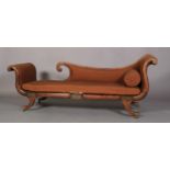 A REGENCY FAUX ROSEWOOD DECORATED DAY BED, the back, scrolling arm and seat upholstered in brown