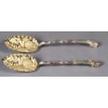 A PAIR OF VICTORIAN SILVER 'BERRY' SPOONS, with fine cast lambrequin terminals, the neck and handles