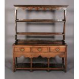 A 19TH CENTURY DRESSER AND RACK, having a moulded cornice above a scalloped frieze, the open back