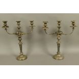 A PAIR OF VICTORIAN SILVER PLATED THREE-LIGHT CANDELABRA, having twin reeded and foliate arms,