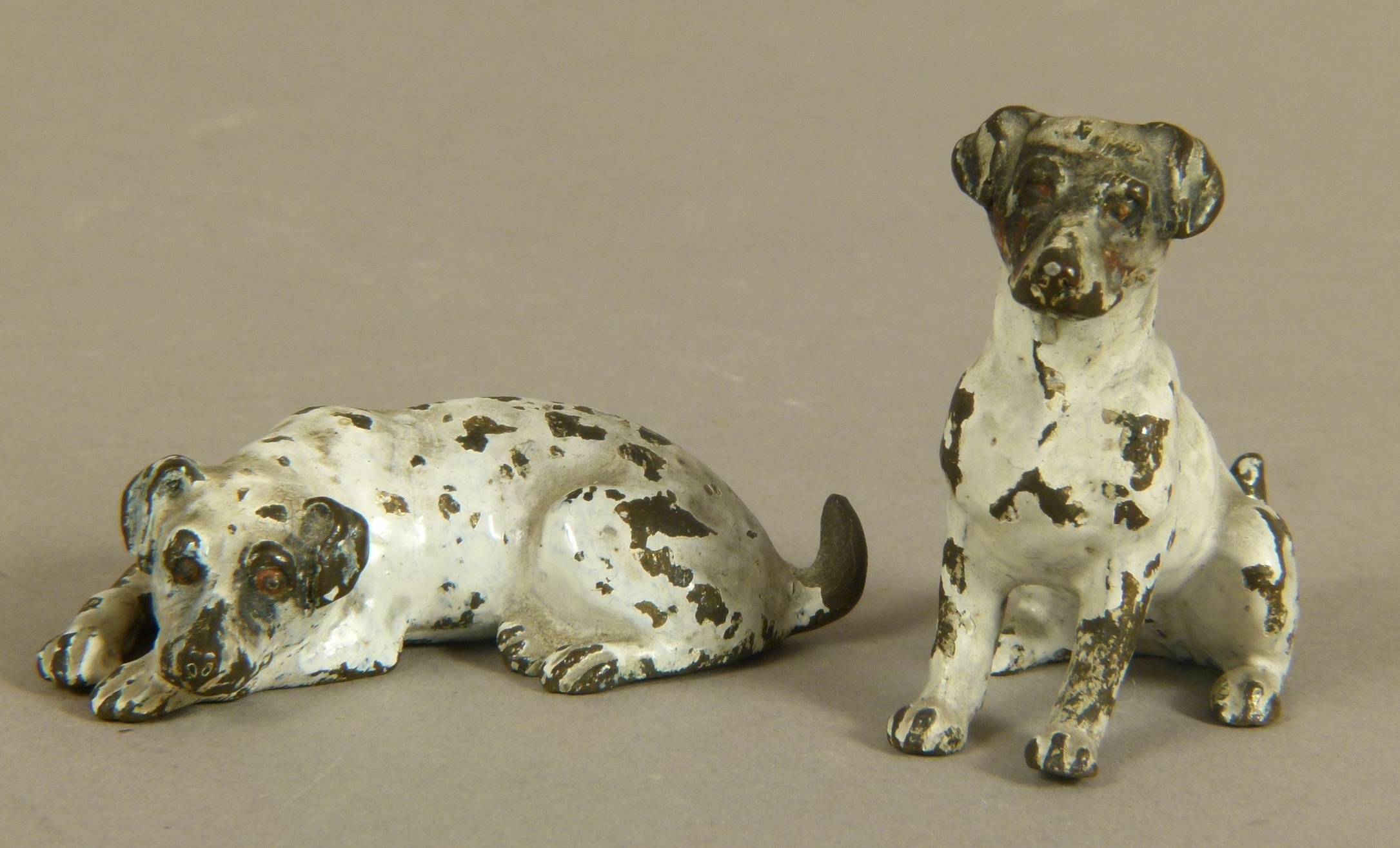 TWO COLD PAINTED BRONZE MODELS OF TERRIERS, one seated, one recumbent, 5cm high (2)