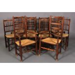 A SET OF TEN ELM SPINDLE BACK RUSH SEATED DINING CHAIRS, early 19th century, on rounded legs and