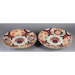 A PAIR OF JAPANESE IMARI CHARGERS c.1880, the circular fluted borders painted in typical palette