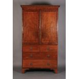 A REGENCY MAHOGANY CLOTHES PRESS, ebony strung throughout, the flared cavetto cornice applied with