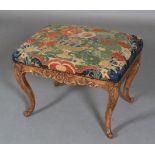 A REGENCY STYLE STOOL IN WALNUT AND BEECH, rectangular, having a needlework upholstered seat,
