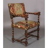 A VICTORIAN OAK ELBOW CHAIR in late 17th century style, the barley twist turned arms terminating