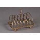 A GEORGE IV SILVER SEVEN BAR TOAST RACK, by William Eley, London 1930, of arched form with leaf