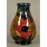 A WILLIAM MOORCROFT POMEGRANATE DESIGN VASE c.1916 of baluster form, tubelined and glazed in ochre