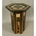 A SYRIAN MOTHER OF PEARL INLAID EBONISED OCCASIONAL TABLE, the hexagonal top with star within a