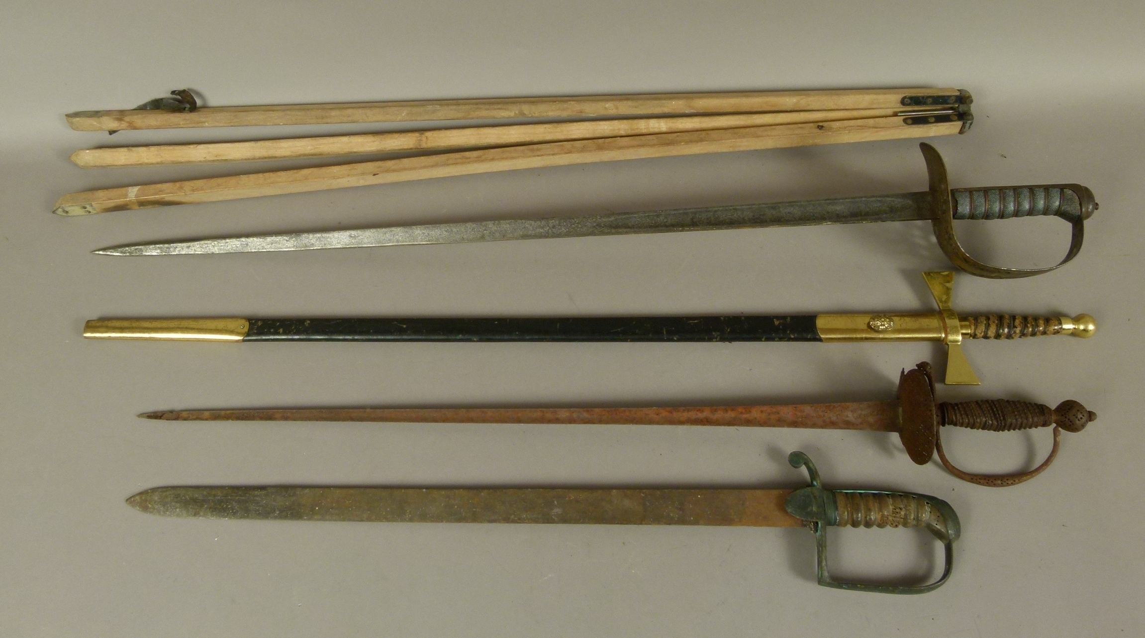 A GROUP OF FOUR SWORDS including a Victorian British Army infantry officer's sword, an early 19th