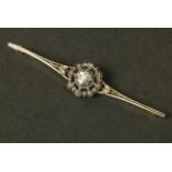 A DIAMOND BAR BROOCH, set to the centre with a foil backed rose cut stone in a cut down setting