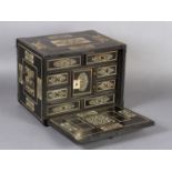 AN EARLY 17TH CENTURY GERMAN EBONY VENEERED AND IVORY INLAID TABLE CABINET inlaid with rectangular