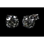 A PAIR OF DIAMOND STUD EARRINGS in 18ct white gold the brilliant cut stones claw set with post and