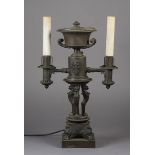 A REGENCY BRONZE COLZA OIL TWIN BRANCH LAMP the two arms issuing from the socle of an urn with