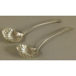 A PAIR OF EARLY GEORGE III SILVER LADLES with shell shaped bowls, feathered edges and engraved