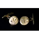 A PAIR OF DIAMOND SET CUFFLINKS, each circular brushed face half embossed with a tulip design and